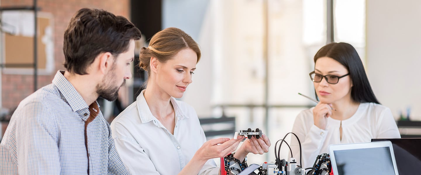 Professional team testing new device in office