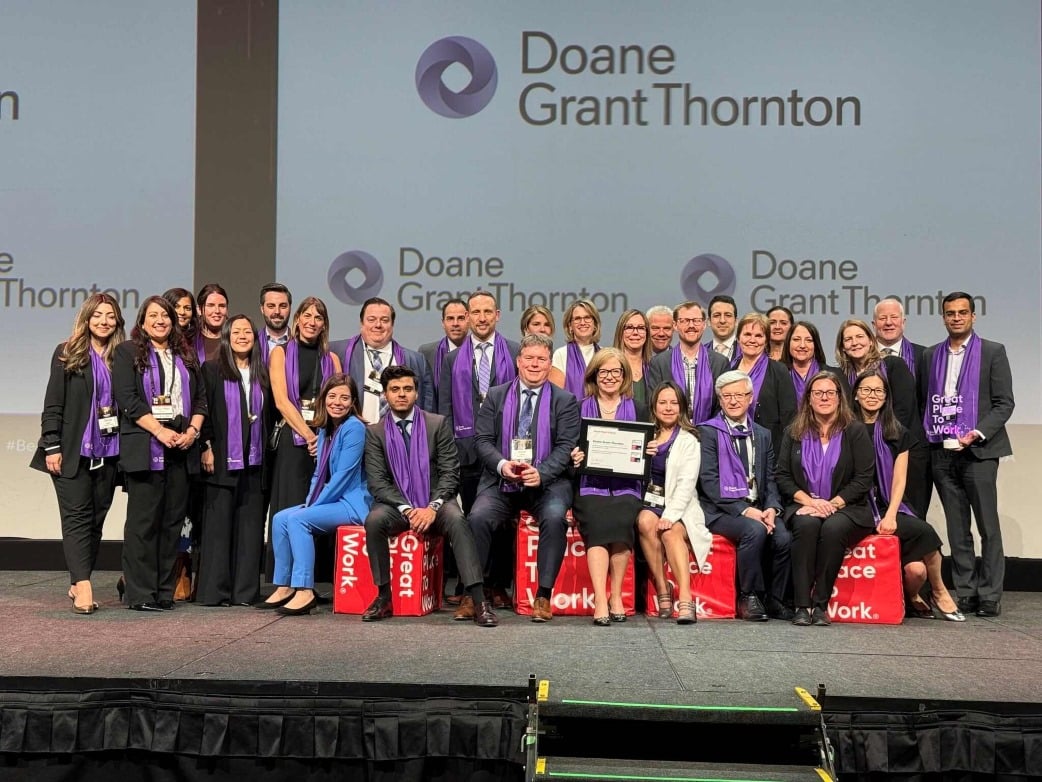 A group of Doane Grant Thornton colleagues on stage for Canada's Best Workplaces for Giving Back award.